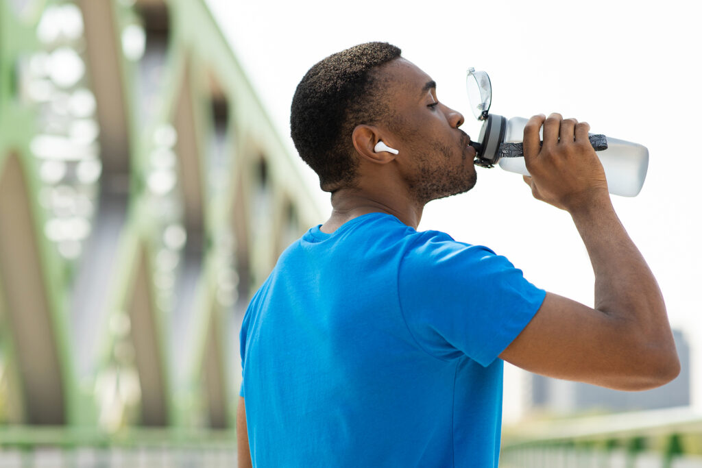 The benefits of hydration. Portrait of a young black man drinking Artezia water from a sports bottle after exercising